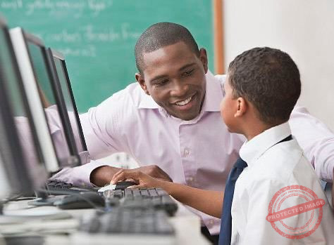 an african creative writing tutor instructing a student at a computer in a classroom setting
